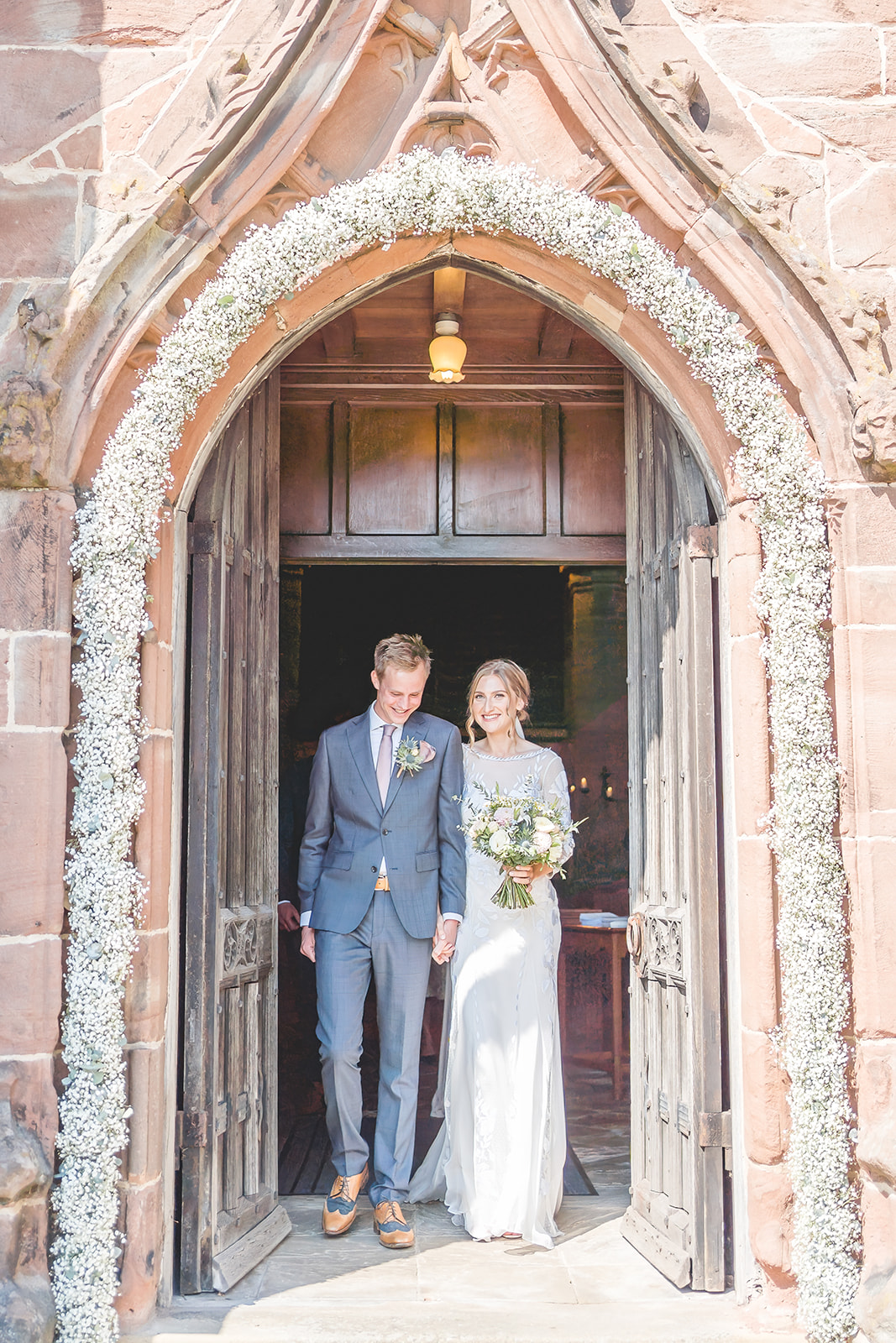 bride and groom exit church ready to head to nunsmere hall