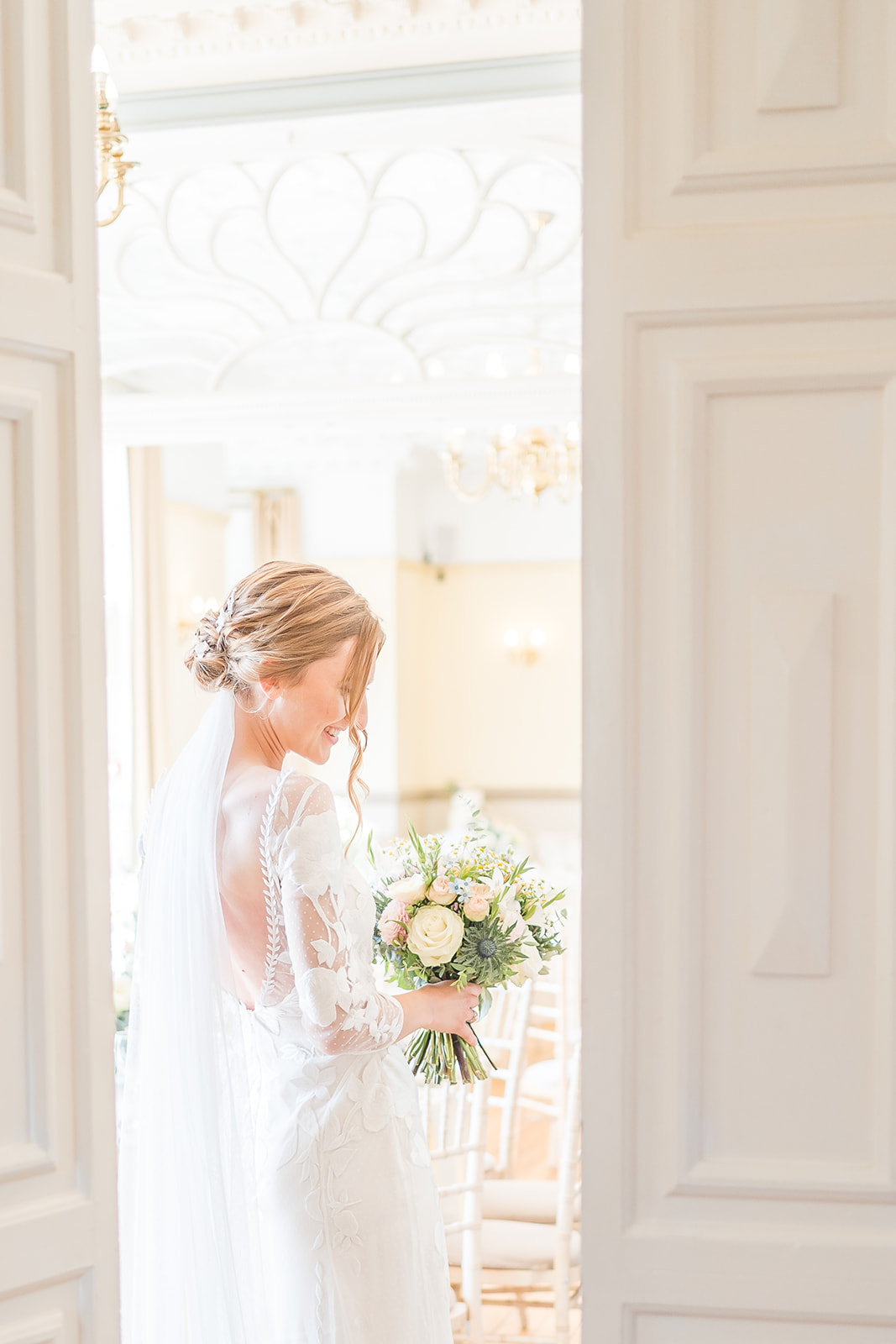 caught glimpse of bride through doorway in Nunsmere hall wedding photography 