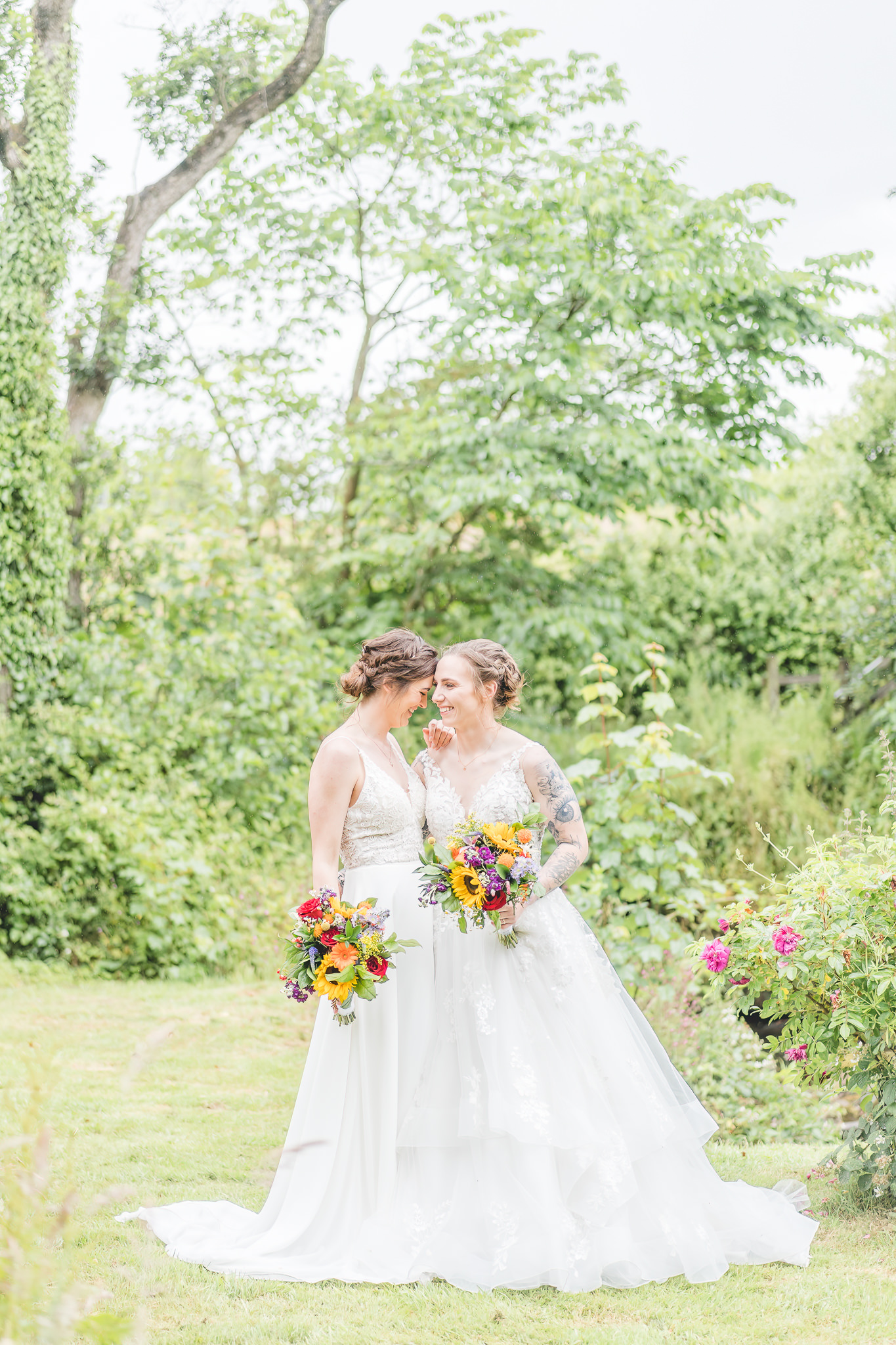 brides laugh with bright sunflower bouquets 