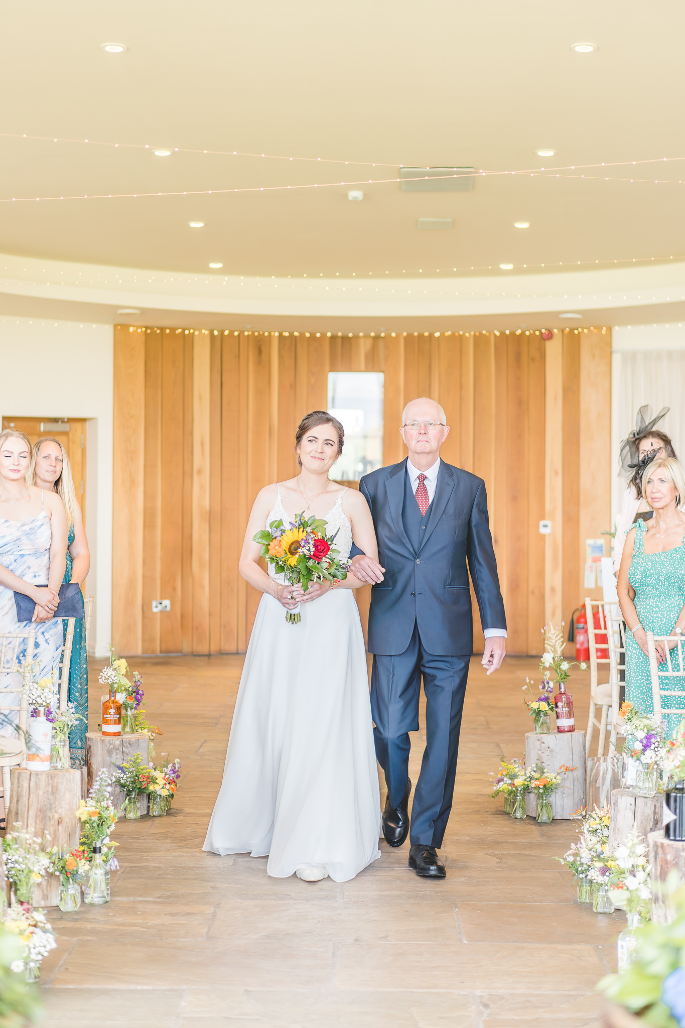 The Out Barn Wedding Photography -  bride walks into ceremony with dad 
