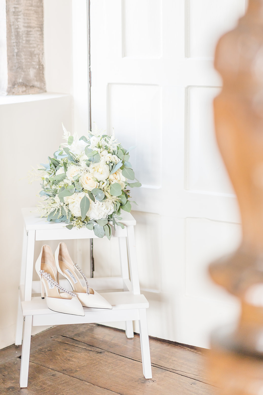 bridal shoes and flowers on stool light and airy wedding photography