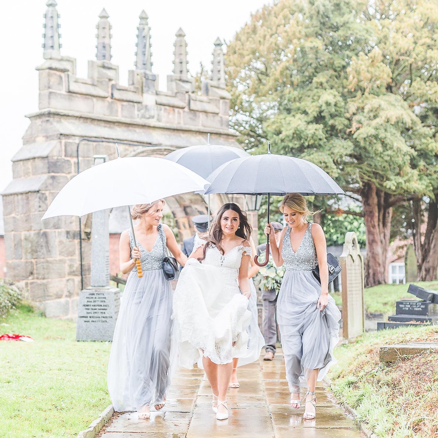 bridal party walk to church in the rain