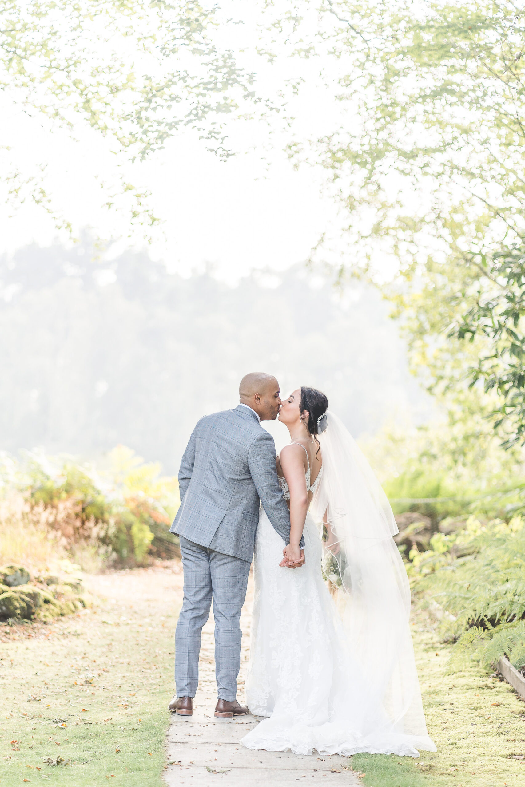 bride and groom kiss in sunshine at Nunsmere Hall