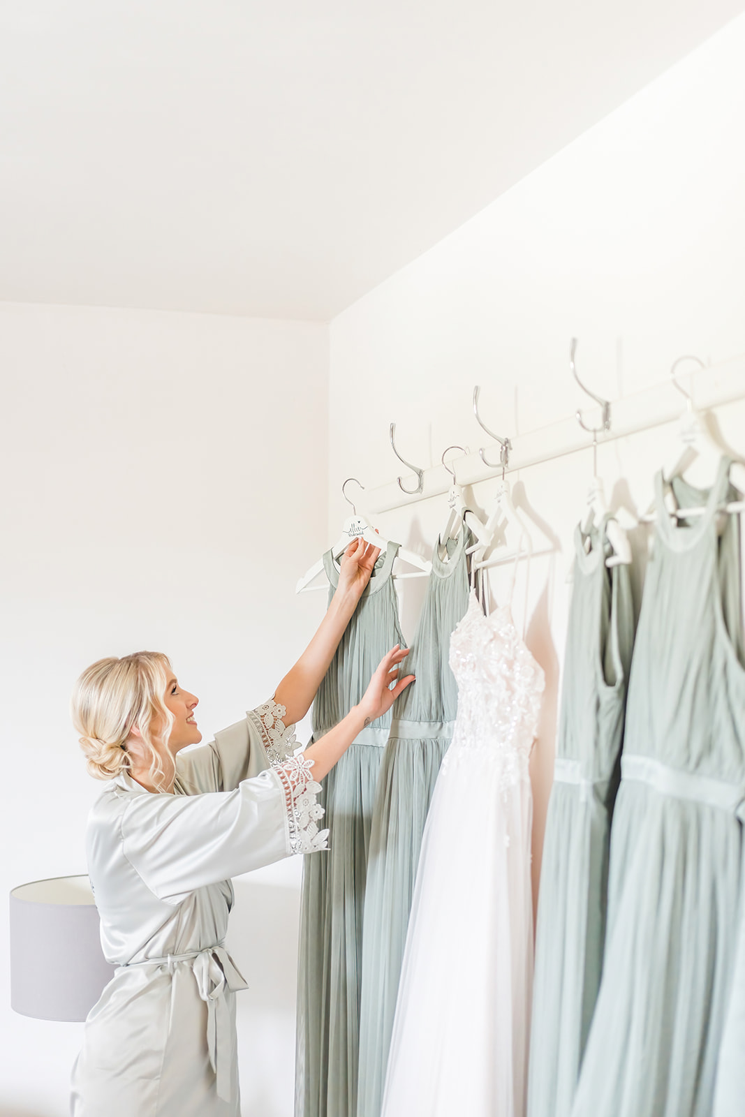 bridesmaid reaches for sage green dresses 