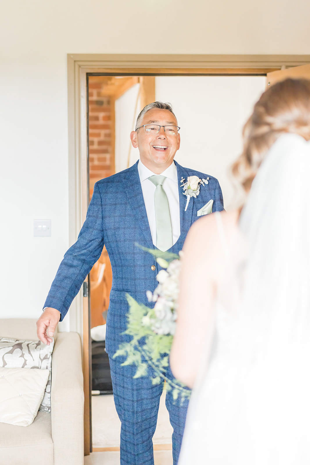 brides father smiles as he sees her 
