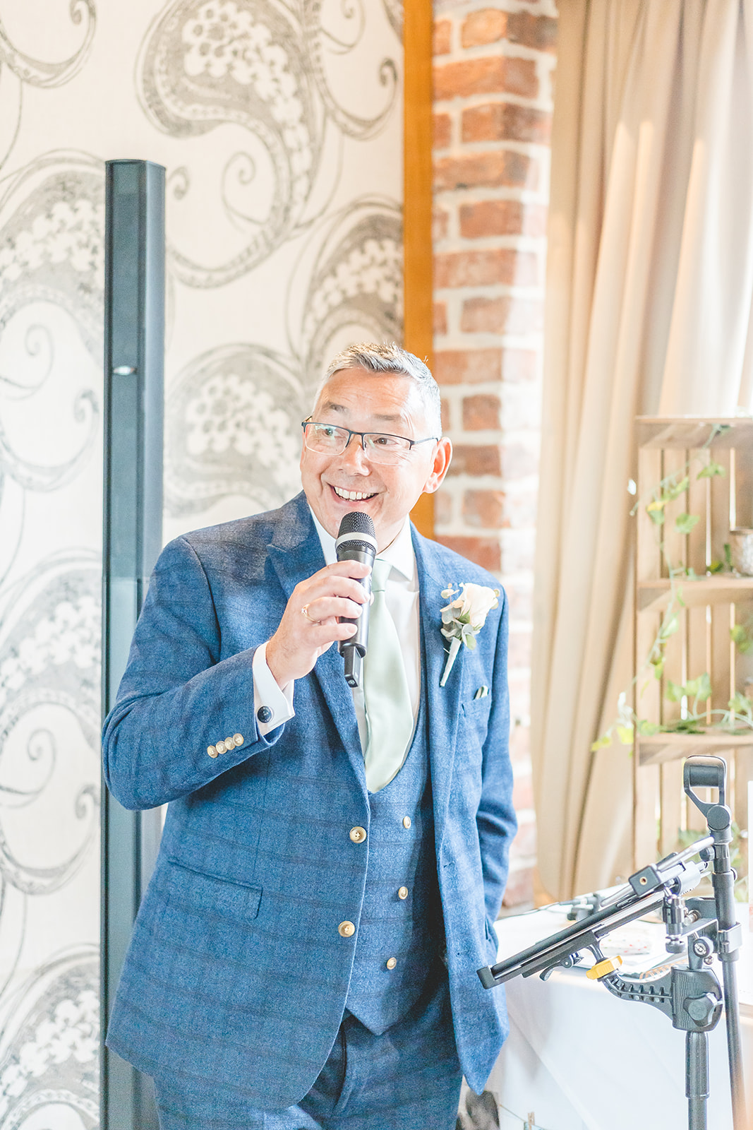 brides father sings on microphone at Curradine Barns 