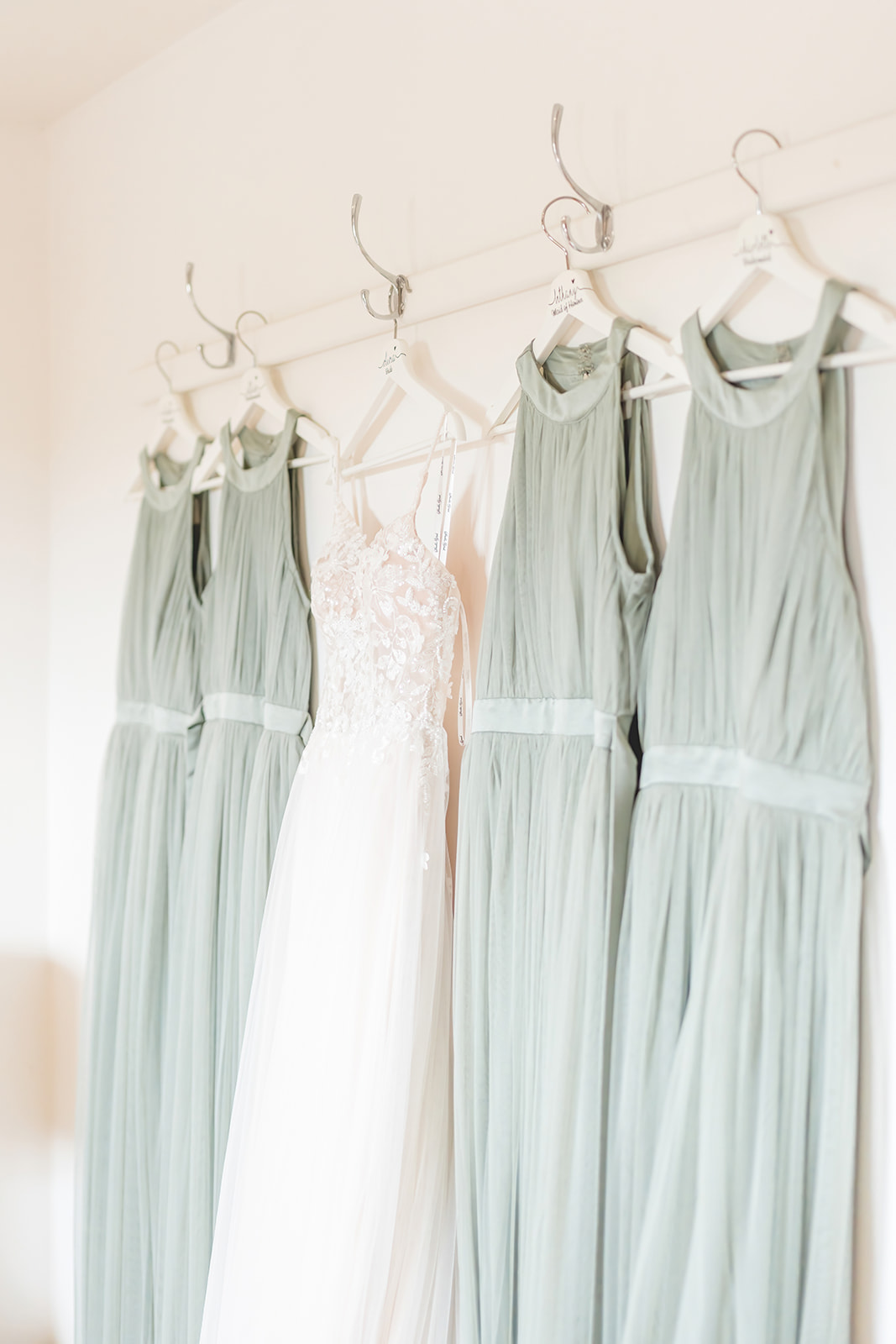 sage green bridesmaids dresses hanging 