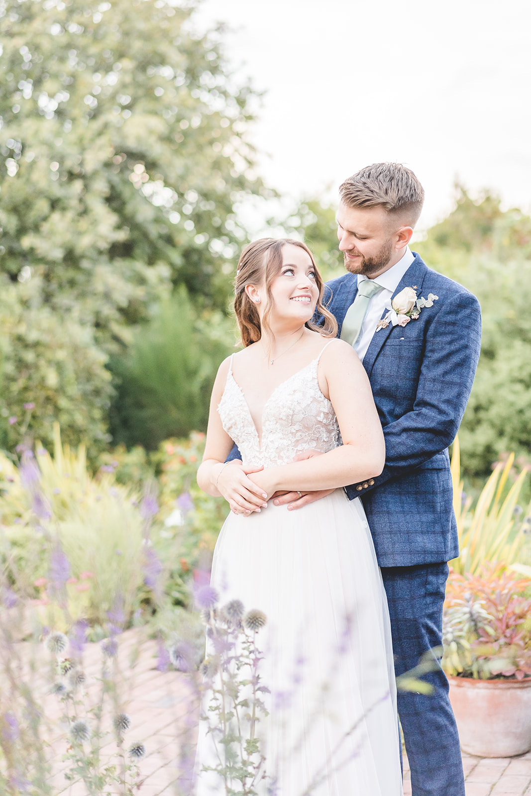 bride and groom portraits with purple flowers 