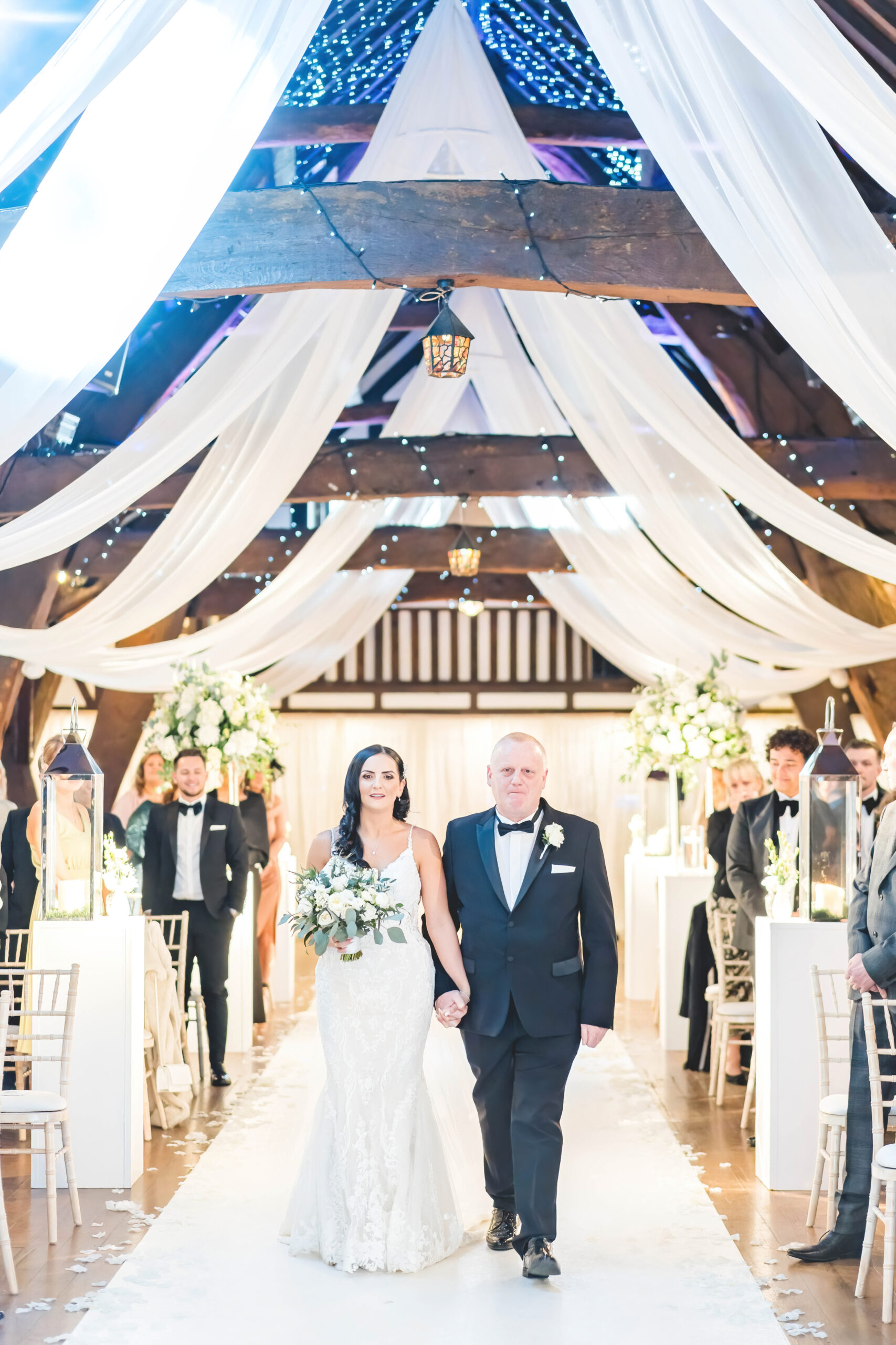 emotional bride and father walk down the aisle 