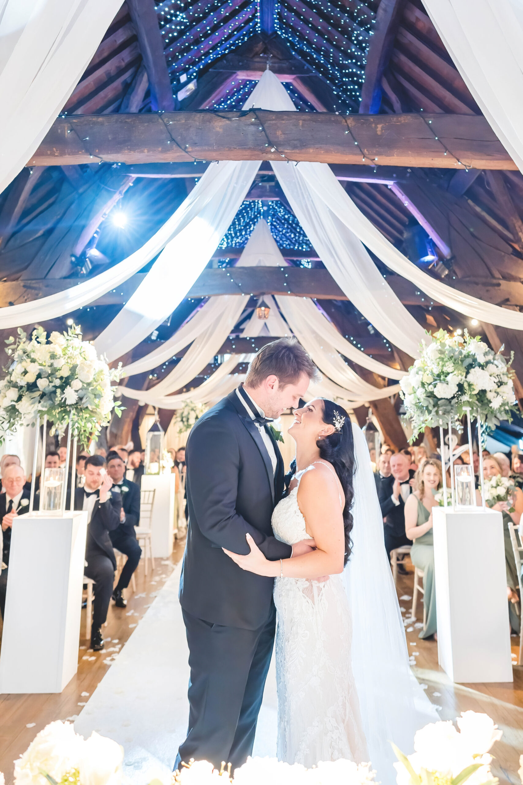 bride and groom first kiss during ceremony at Rivington Hall Barn 