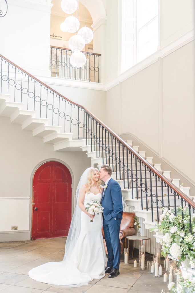 bride and groom below the stairs at Saltmarshe Hall Wedding