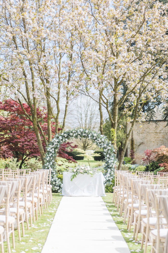 outdoor ceremony under the blossom at Saltmarshe Hall Wedding