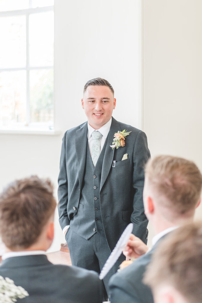 groom waits at the top of the aisle at iscoyd park wedding venue