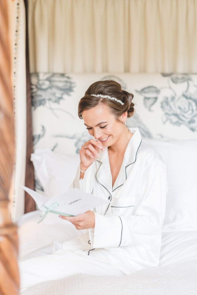 emotional bride reads card in bedroom at iscoyd park 